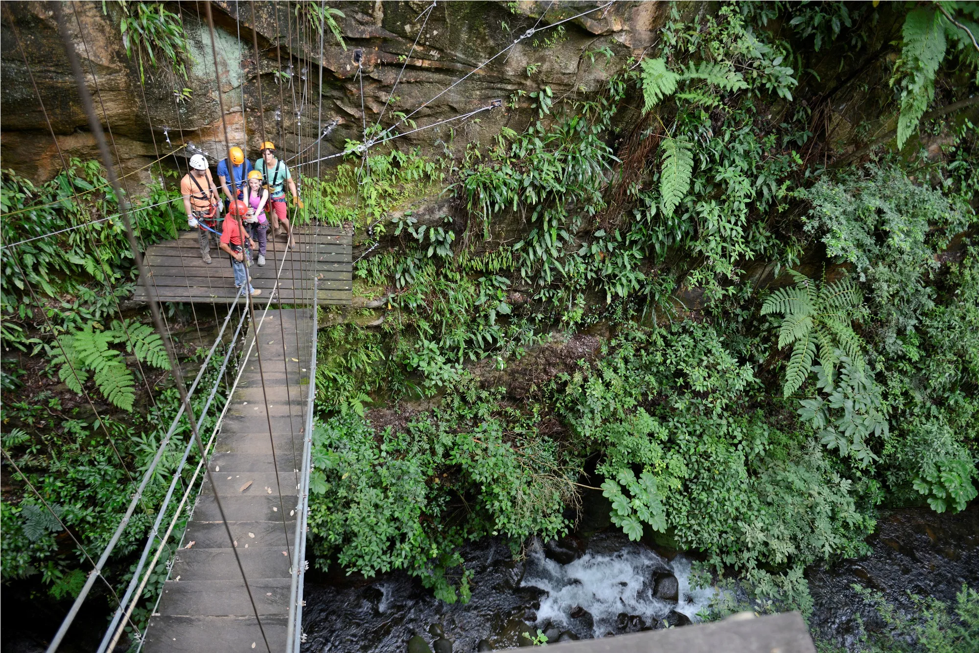 Tourists preparing for a ziplining adventure over the lush landscapes of Costa Rica, an exhilarating experience with CRSTours.